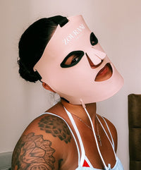 Close-up van vrouw met Zourani LED Face Masker voor roodlichttherapie thuis